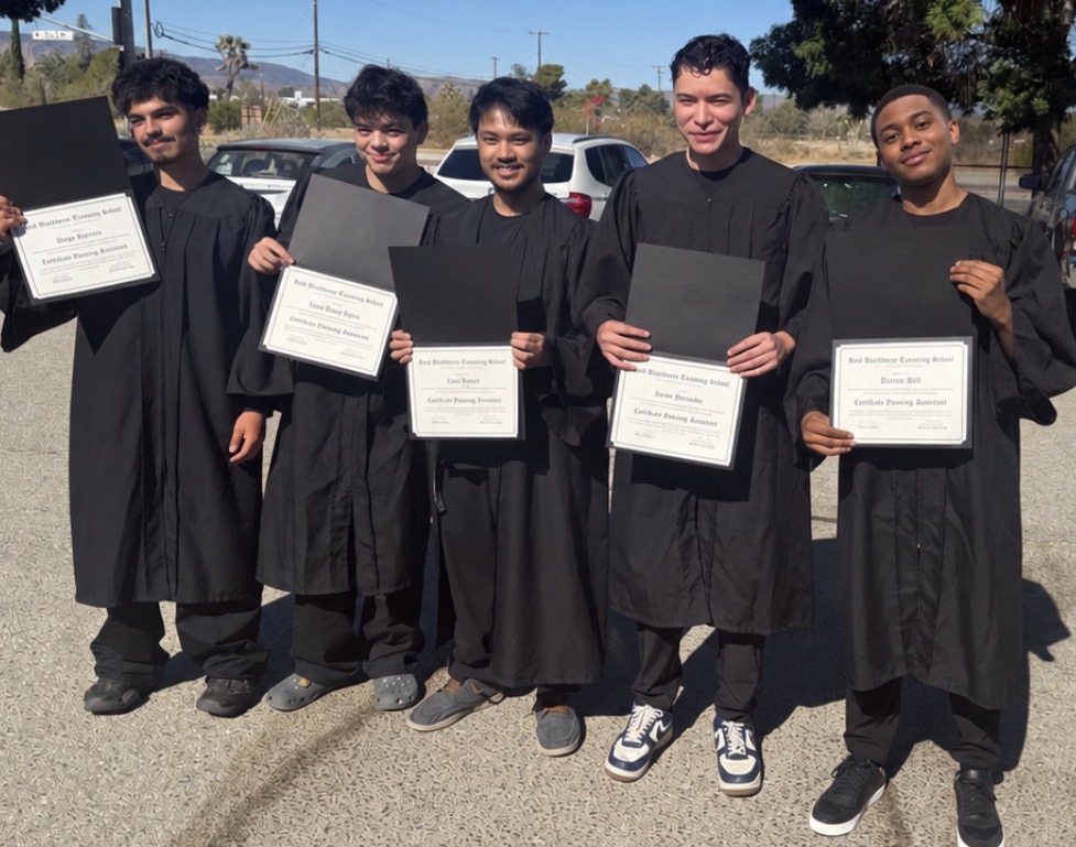 Five Bell graduates holding their certificates